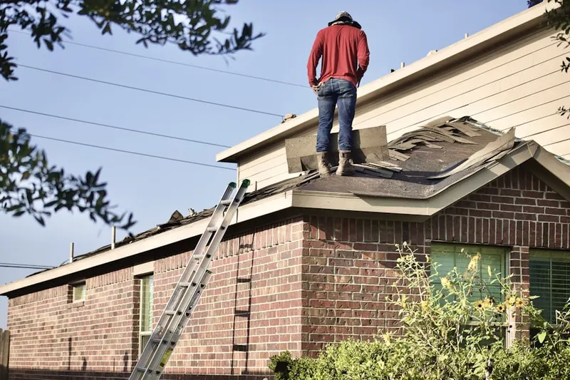 Professional roofer working on a residential roof in Wildrose Valley